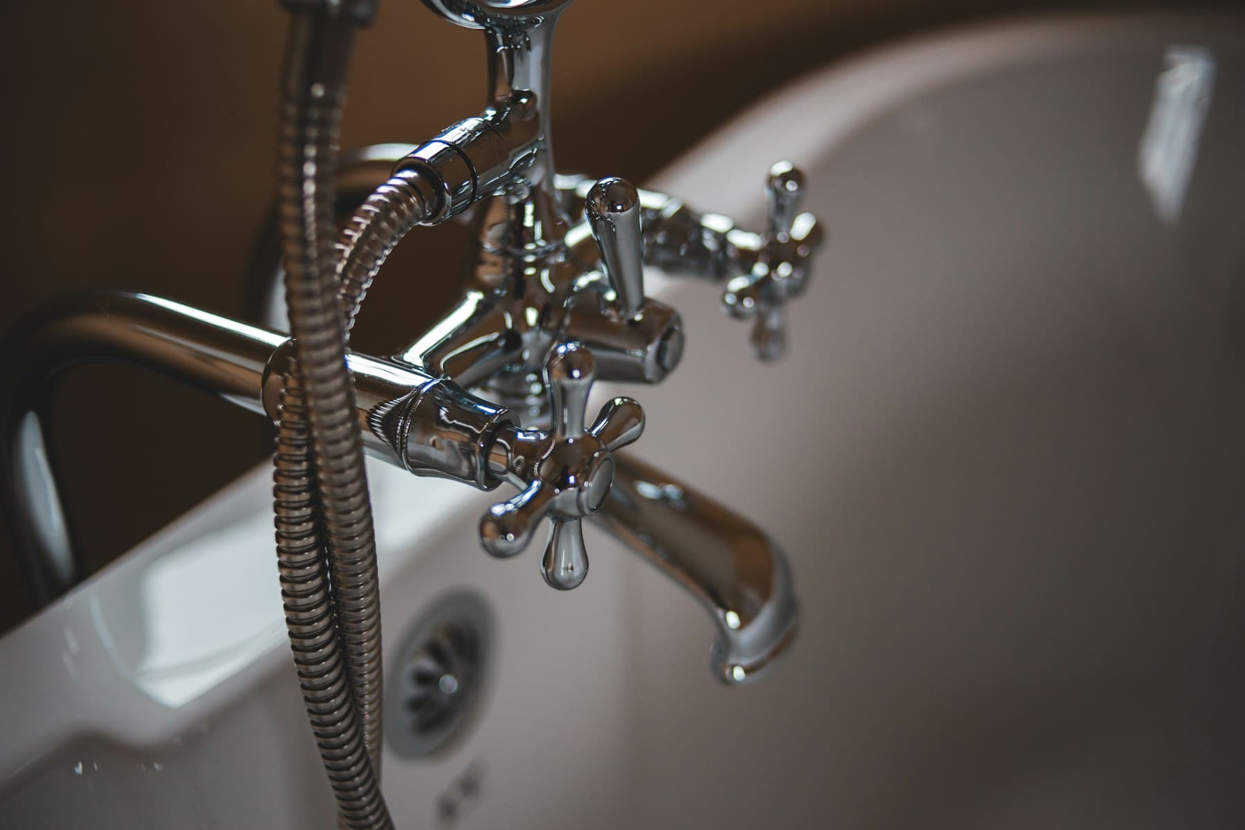 Chrome bathtub faucet and handheld shower